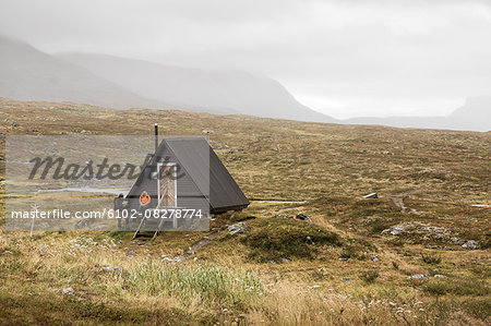 Couple near wooden building in mountains