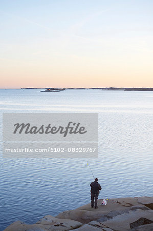 Man fishing at dusk