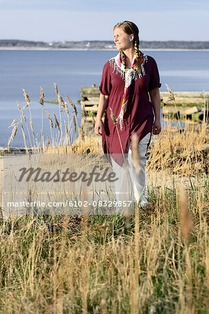 Smiling woman waling on meadow