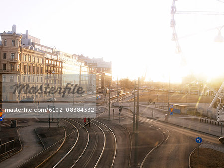 Tram tracks in city with the Liseberg Wheel in the foreground in Gothenburg, Sweden