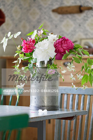 Flowers in bucket on table