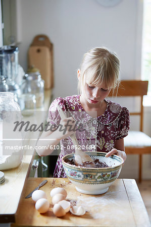 Girl mixing flour