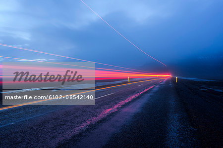 Light trail on road at dusk