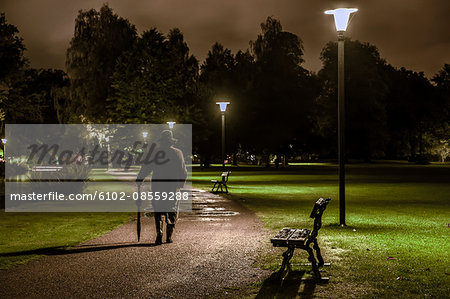 Man walking through park at night, Ronneby, Blekinge, Sweden