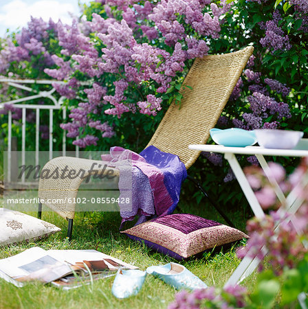 Outdoor furniture in a flowering garden, Sweden.