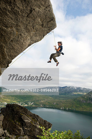 Man hanging on rope while climbing - Stock Photo - Masterfile - Premium  Royalty-Free, Code: 6102-08566202