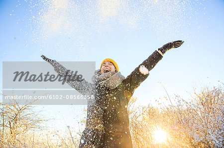 Woman throwing snow