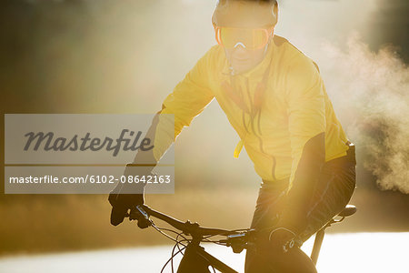 Man cycling on a frozen lake