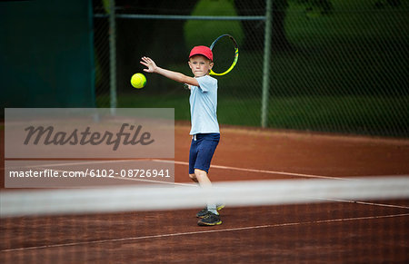 Boy playing tennis