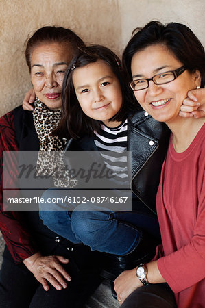 Girl embracing her mother and grandmother
