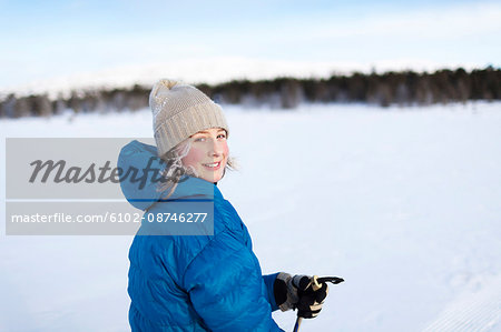 Girl skiing in knit hat on snow field