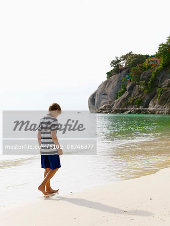 Boy walking on beach