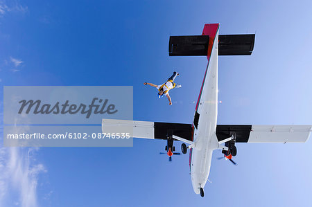 Parachutists jumping from airplane