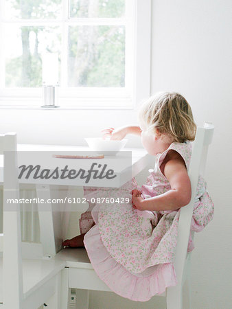 Girl sitting at table eating