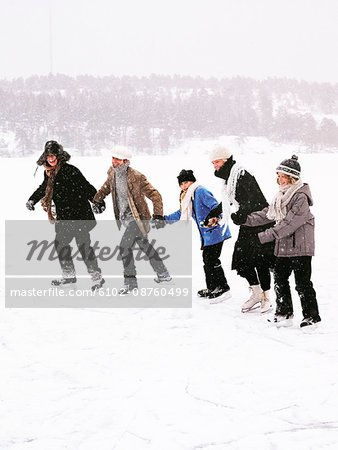 Five people skating holding hands.