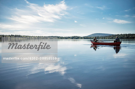 People in boat on lake