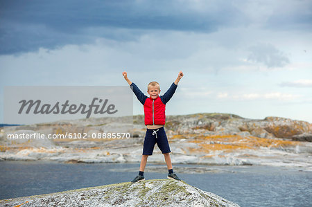 Boy on top of rock