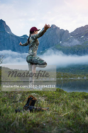 Woman in mountains doing yoga