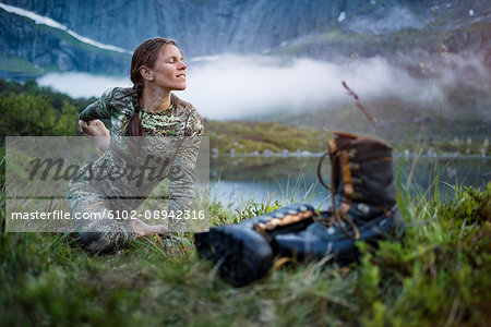 Woman in mountains doing yoga