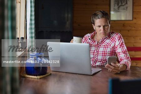 Woman at home using laptop