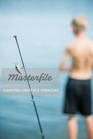 Fishing rod and boy in background - Stock Photo - Masterfile - Premium  Royalty-Free, Code: 6102-08942546