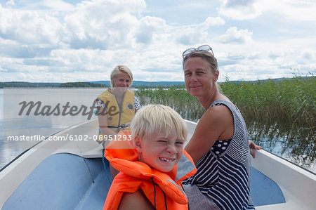 Mother with children on boat