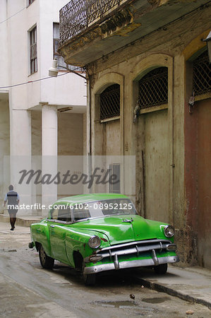 Vintage car parked in front of old building