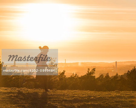 Woman running at sunset