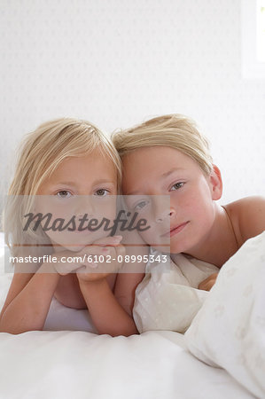 Portrait of sibling in bed