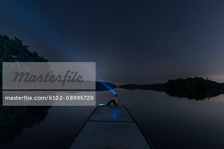 Person with headlight on jetty