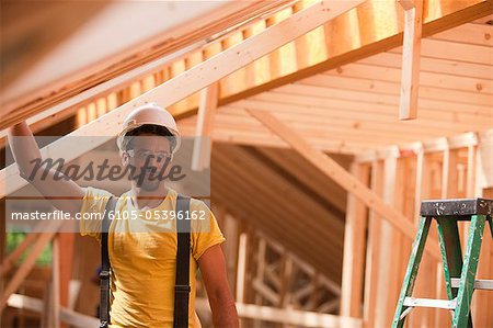 Hispanic carpenter working at a house under construction