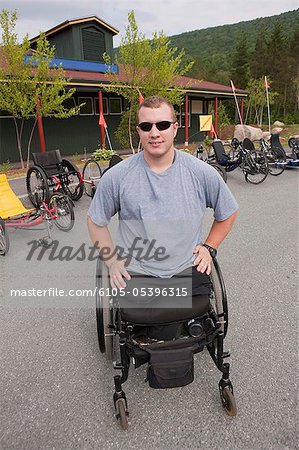 Man with leg amputee in a wheelchair preparing for a race