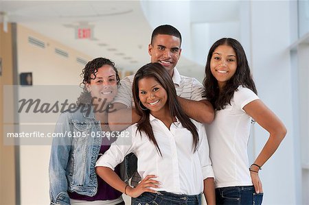 Portrait of four university students smiling