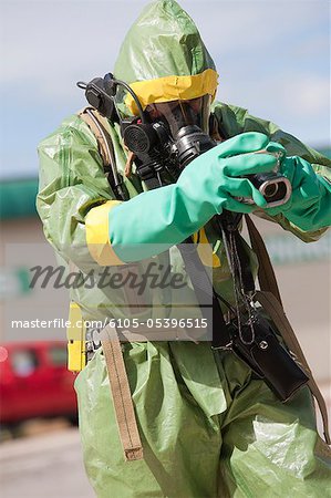 HazMat firefighter working with a camera to log the accident