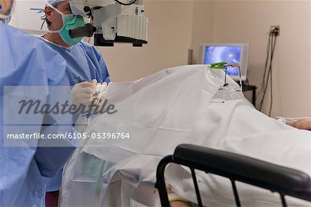 Doctor using forceps to score the cataract