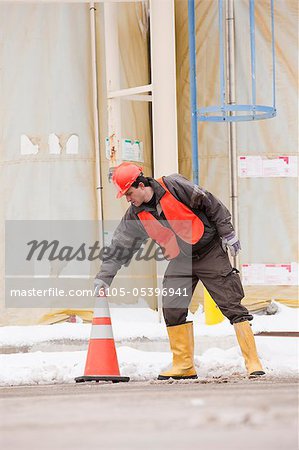 Transportation engineer moving traffic cones at a construction site