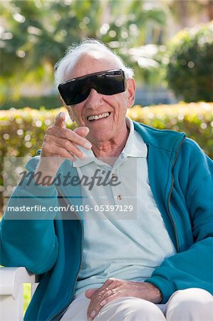 Senior man wearing cataract dark glasses