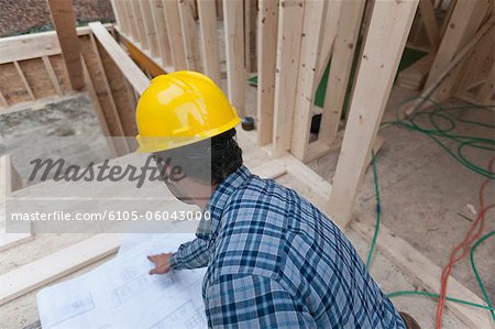 Carpenter reviewing house plans