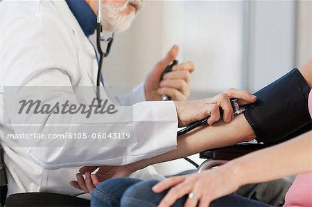 Doctor checking the blood pressure of a patient