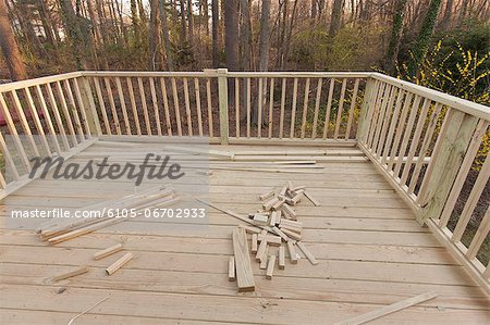 New deck under construction on home with railing in place