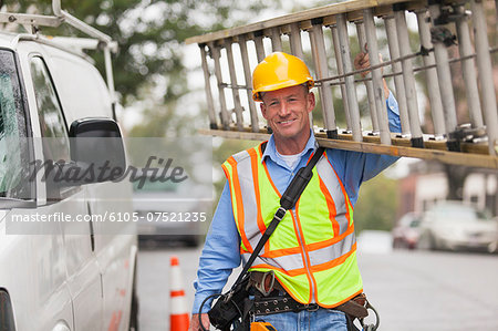 Cable lineman carrying ladder from service truck