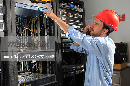 Network engineer on phone performing trouble shooting Network engineer on phone performing trouble shooting
