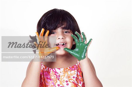 Portrait of a young girl with colored palms