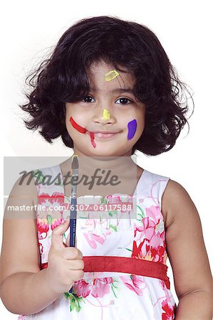 Portrait of a girl with paint brush