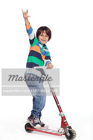 Portrait of little boy with foot push skate cycle