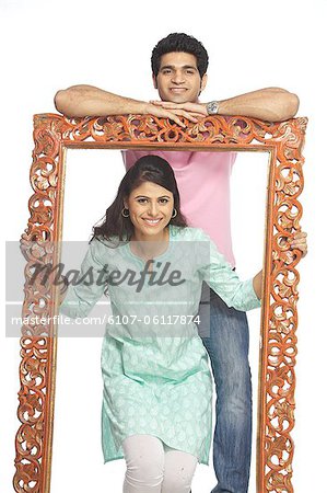 Portrait of a happy couple with a frame