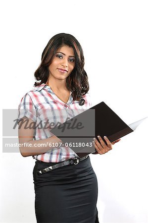 Portrait of young business woman holding file