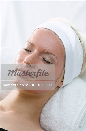 Young Woman face with beauty mask, shut eyes