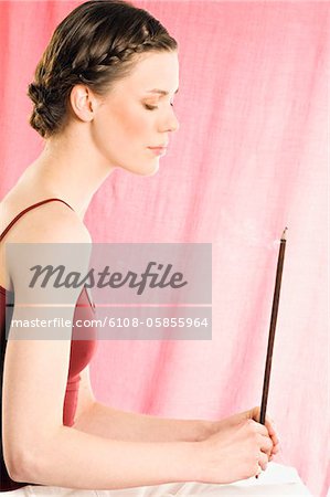 Woman holding incense stick