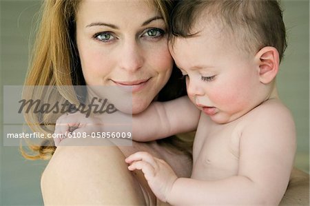 Portrait of mother and baby, naked shoulders